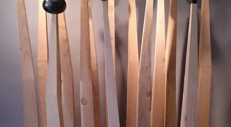 Minoru Ohira, grouping of sculptures, 2017, wood and graphite, wood bases 5"x 5"x 50" to 65", wood and graphite tops 5"x 5" x 8" to 15"