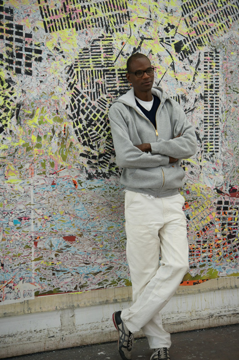 Mark Bradford at his Los Angeles studio in front of a work in progress. Photo by Tyler Hubby.