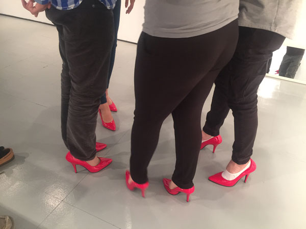 Gallerygoers try on Gaulke's red heels.